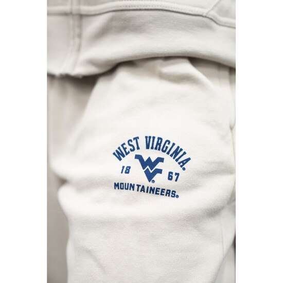 Close up of the navy WVU graphic on front left hip of the cocoa butter WVU women's sweatpants